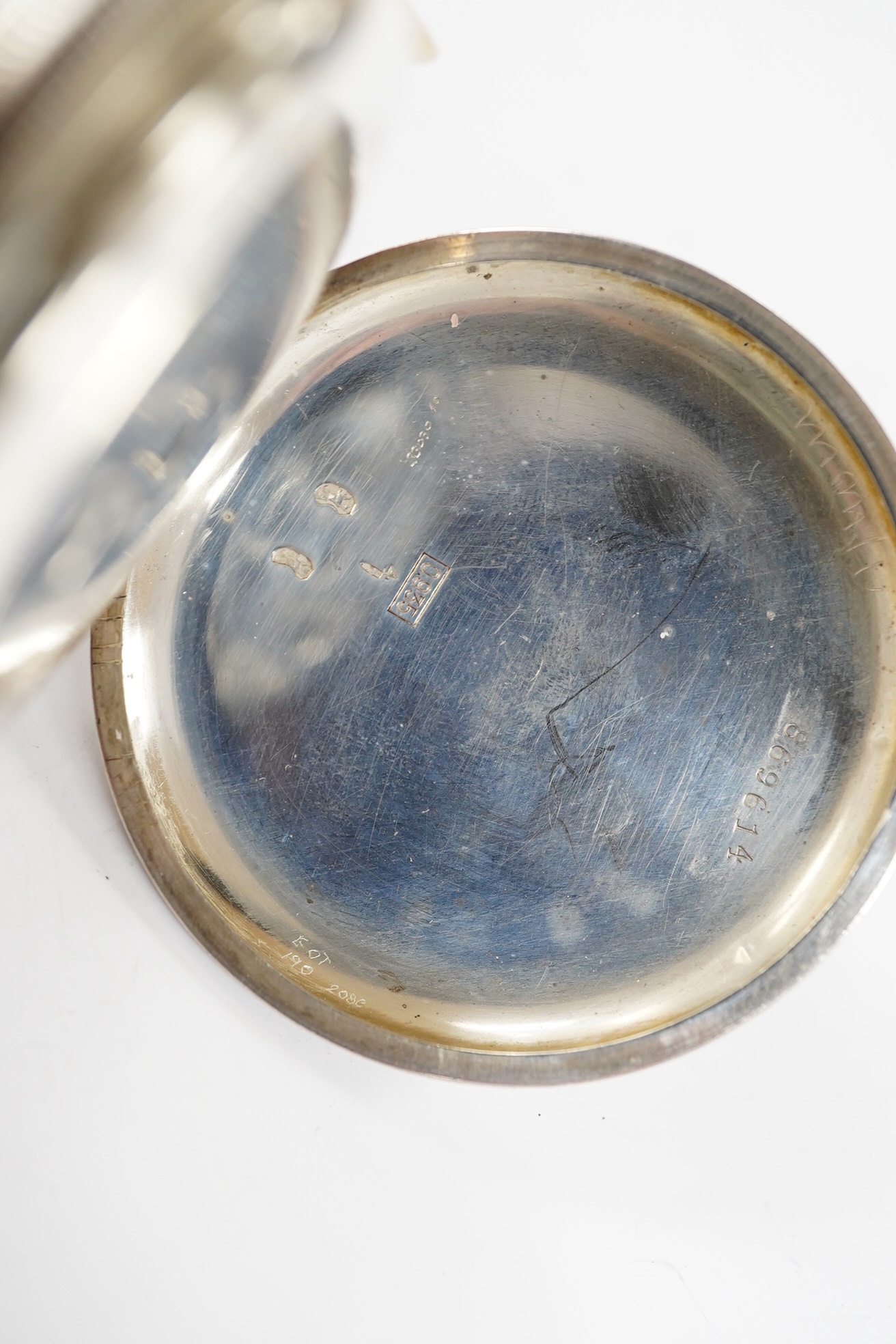 A late 19th century engine turned Swiss 935 standard white metal key wind open faced pocket watch, with engraved inscription relating to J.B. Dent & Sons, London, case diameter 53mm. Condition - fair